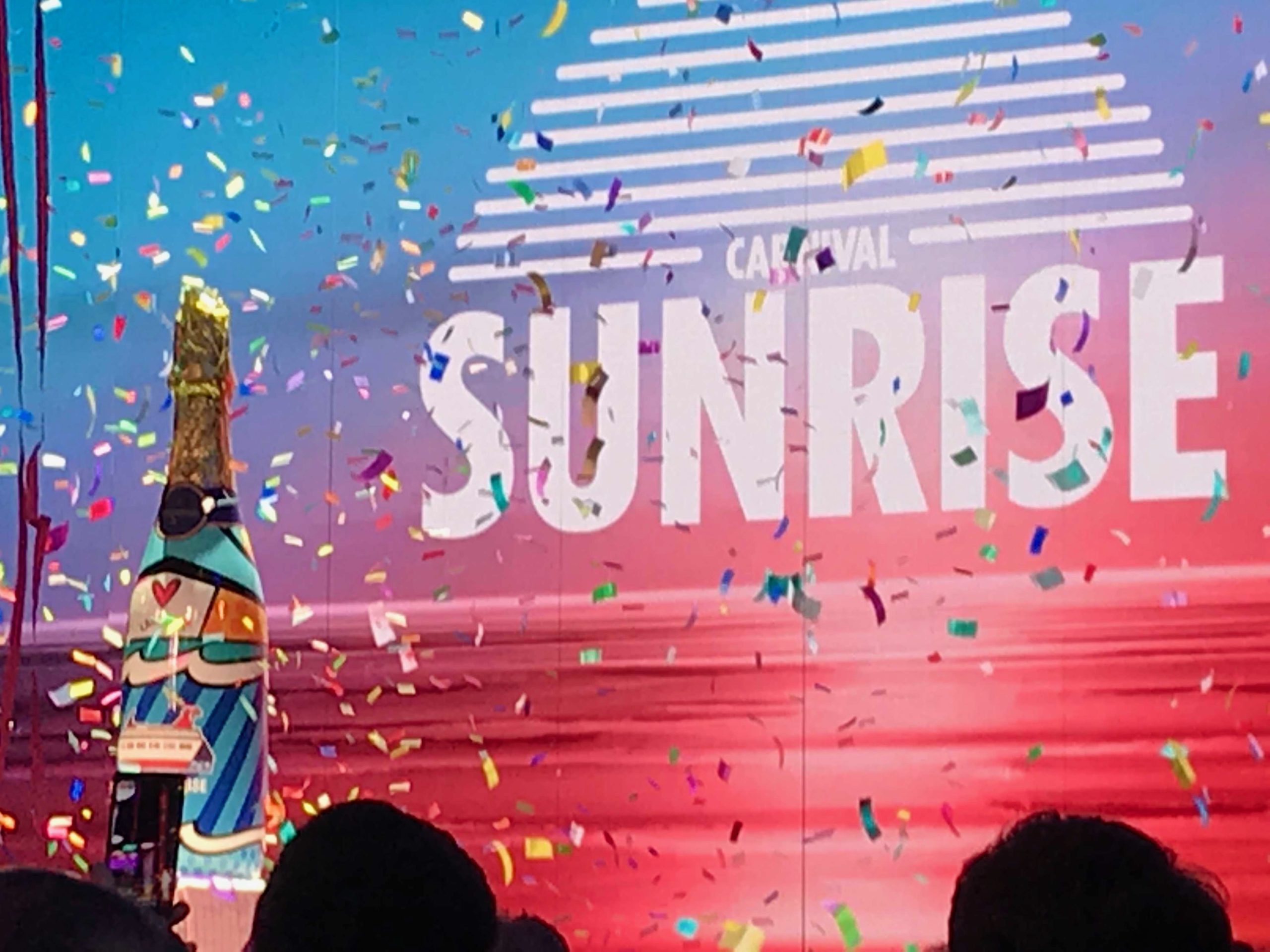 At the naming of Carnival Sunrise, a giant bottle sprays confetti.